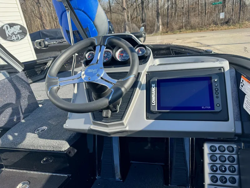 Slide: The Image of 2024 Ranger 1880MS boat dashboard with steering wheel and Lowrance Elite fishfinder. - 5