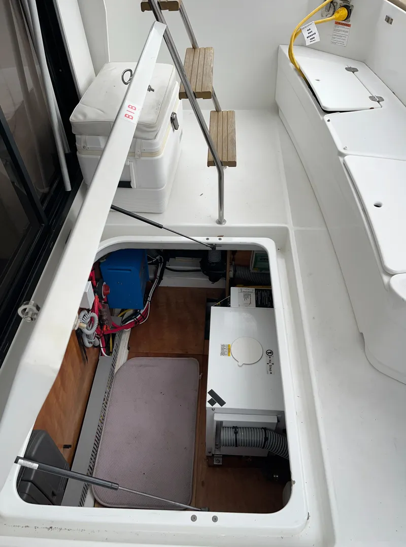 Slide: The Image of 2013 Beneteau Swift Trawler 34 engine compartment with open hatch and visible equipment. - 13