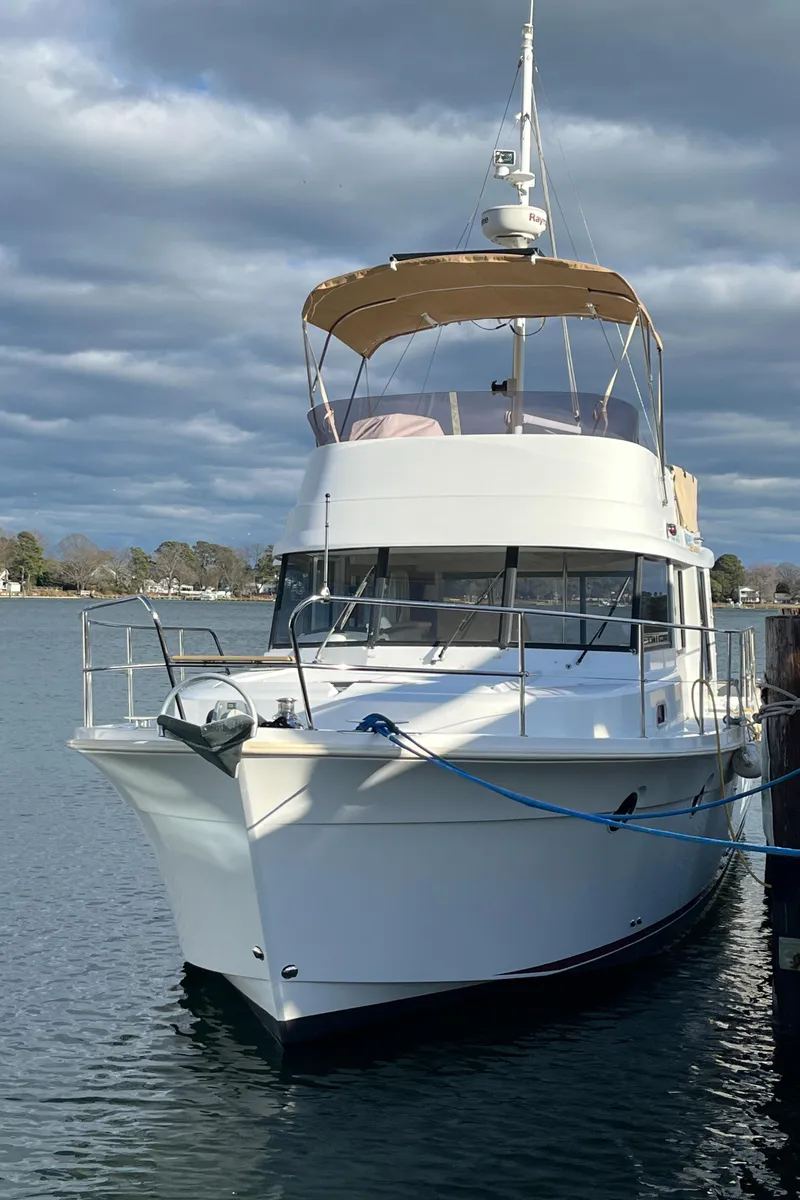 Slide: The Image of 2013 Beneteau Swift Trawler 34 docked on a calm, cloudy day. - 3