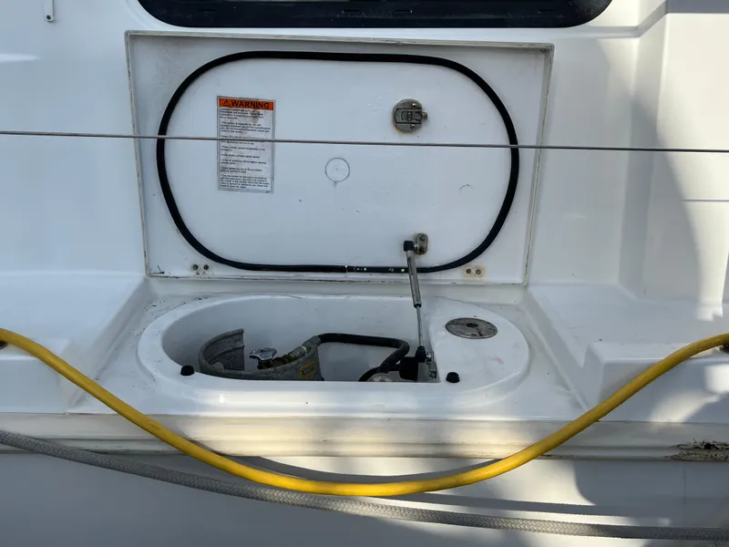 Slide: The Image of 2013 Beneteau Swift Trawler 34 deck detail with utility compartment and hose. - 31