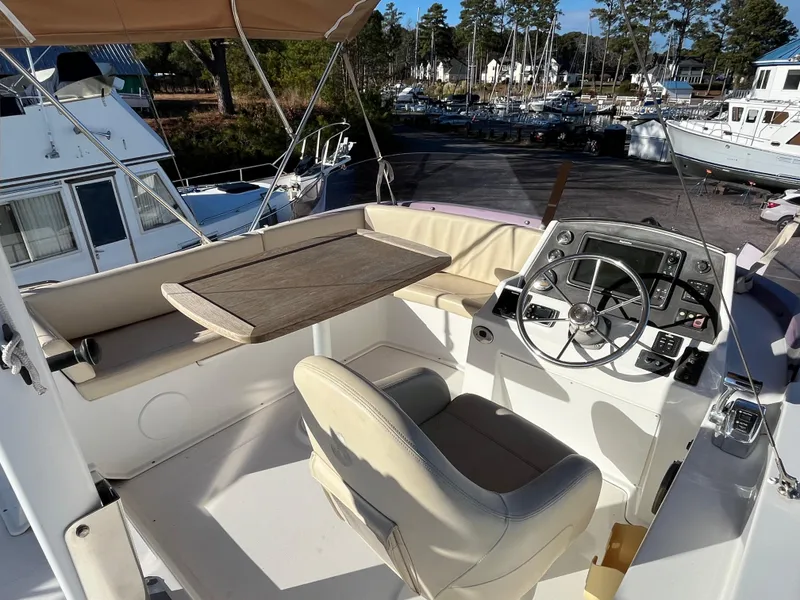 Slide: The Image of Flybridge of 2013 Beneteau Swift Trawler 34 with helm, seating, and table. - 35