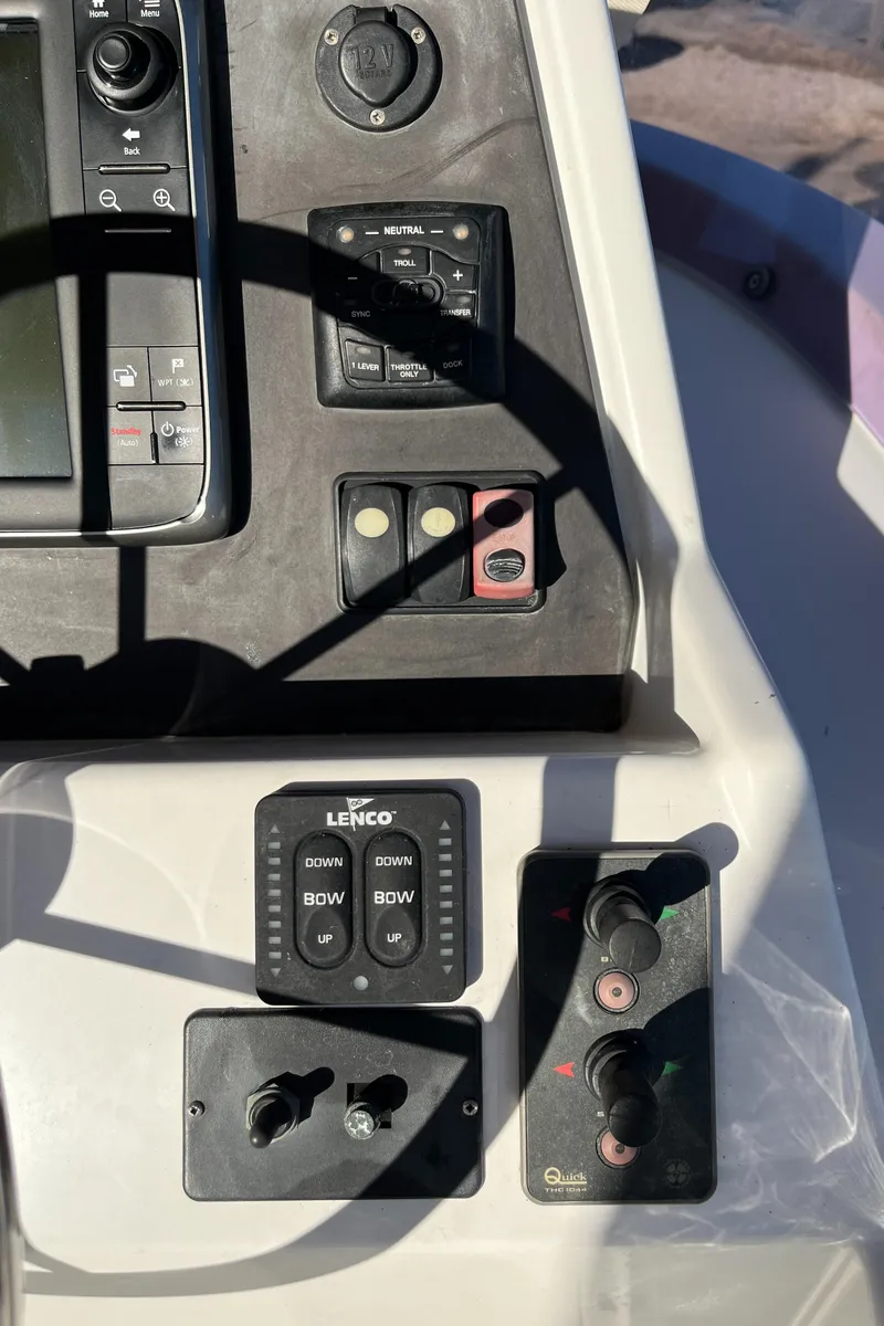 Slide: The Image of Control panel of a 2013 Beneteau Swift Trawler 34 with navigation and trim controls. - 40