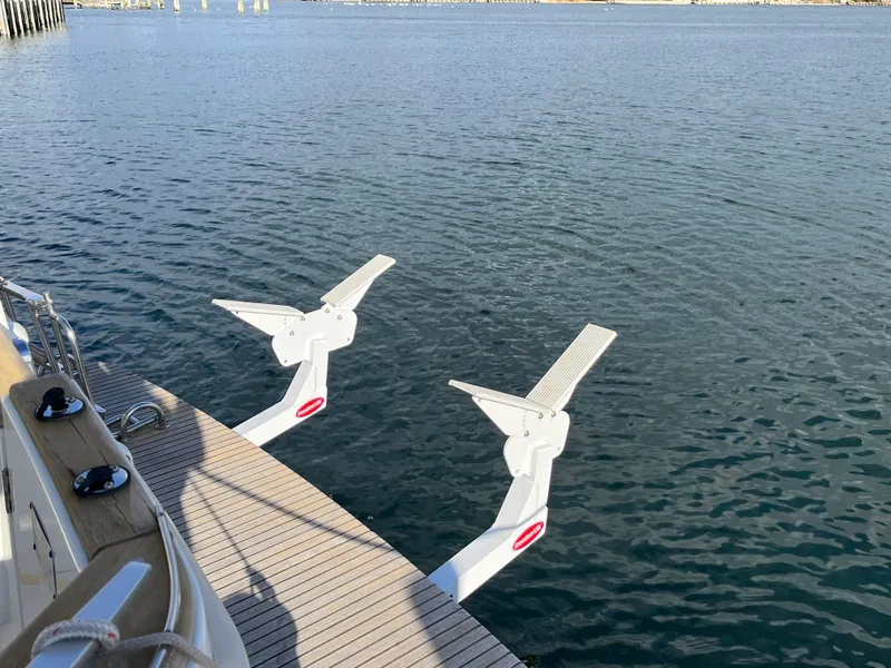 Slide: The Image of 2013 Beneteau Swift Trawler 34 with swim platform and davits on calm water. - 5