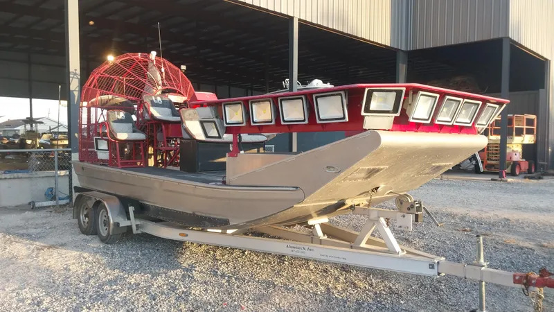 Slide: The Image of 2010 Airboat 18x8 on trailer, parked in industrial area. - 3