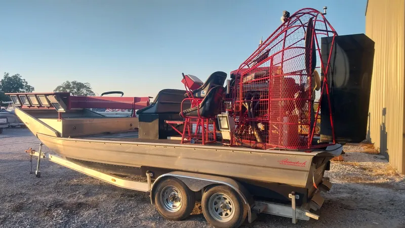 Slide: The Image of 2010 Airboat 18x8 on a trailer, parked outdoors. - 4