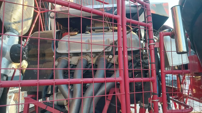 Slide: The Image of Close-up of a 2010 Airboat 18x8 engine behind a red protective cage. - 5