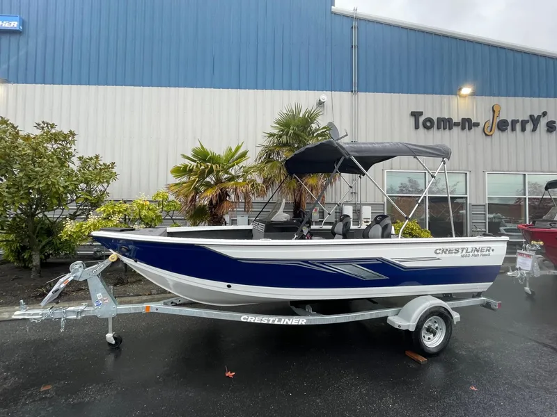 The Image of 2024 Crestliner 1650 Fish Hawk SC boat on trailer, parked outside dealership. - 1