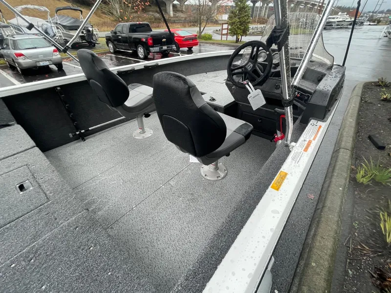 Slide: The Image of 2024 Crestliner 1650 Fish Hawk SC boat interior with seating and steering console. - 8