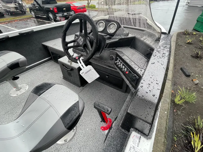 Slide: The Image of 2024 Crestliner 1650 Fish Hawk SC boat interior with steering wheel and controls. - 9