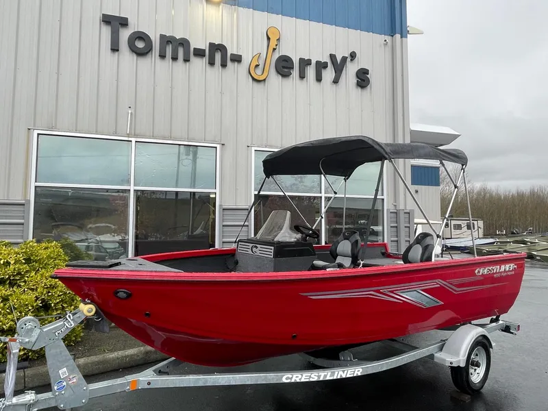 The Image of 2021 Crestliner 1650 Fish Hawk SC boat in red, parked outside Tom-n-Jerry's store. - 1