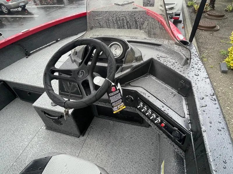 Slide: The Image of 2021 Crestliner 1650 Fish Hawk SC boat interior with steering wheel and control panel. - 11