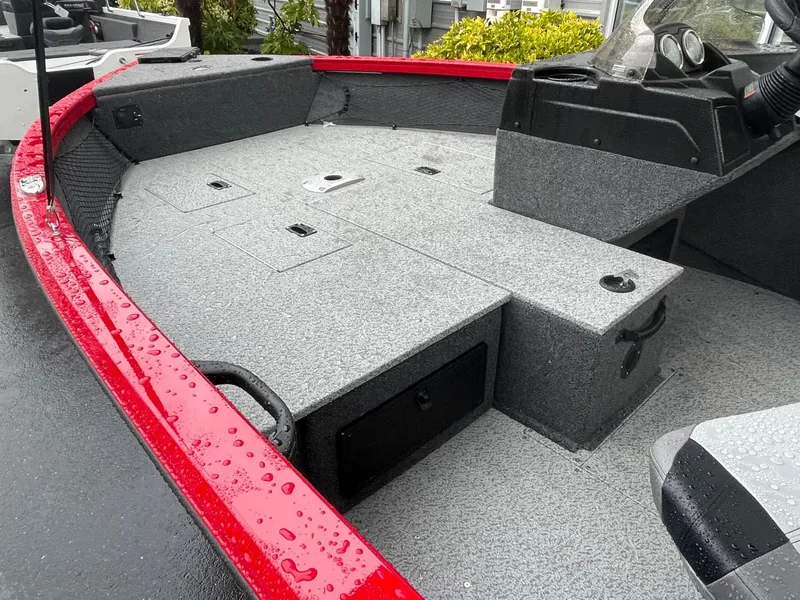 Slide: The Image of 2021 Crestliner 1650 Fish Hawk SC boat interior with red trim and storage compartments. - 13