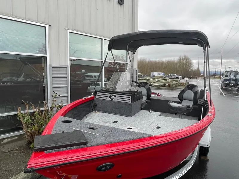 Slide: The Image of 2021 Crestliner 1650 Fish Hawk SC boat, red exterior, parked outdoors. - 3