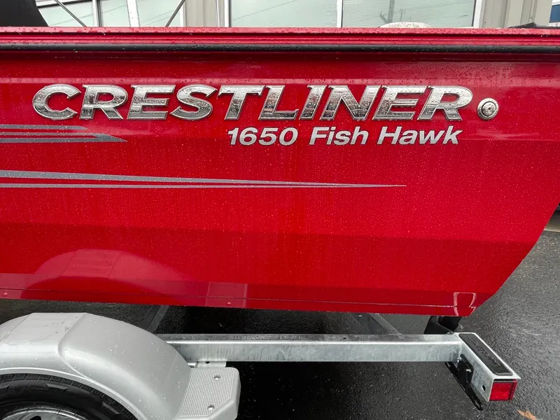 Slide: The Image of Red 2021 Crestliner 1650 Fish Hawk SC boat on trailer, side view. - 5
