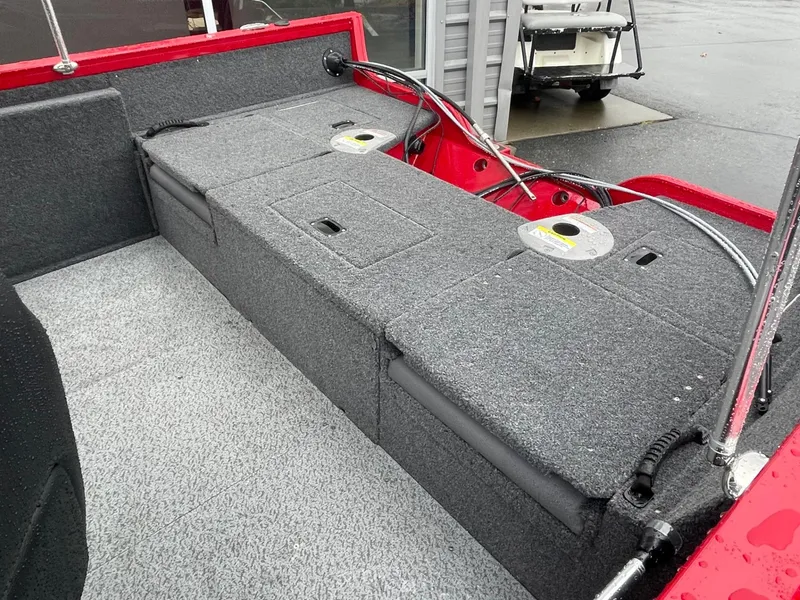 Slide: The Image of 2021 Crestliner 1650 Fish Hawk SC boat interior with storage compartments and red accents. - 6