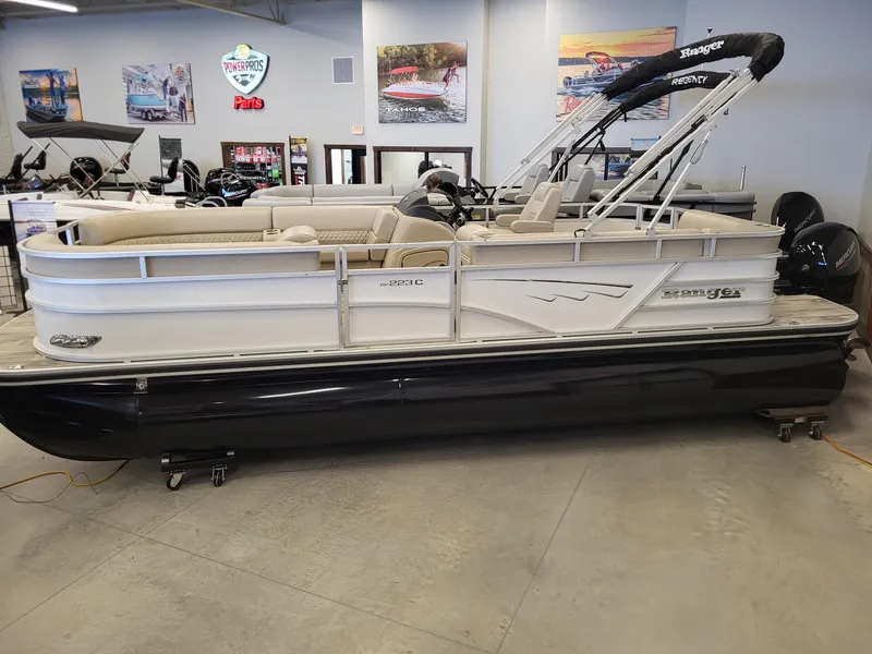 Slide: The Image of 2024 Ranger Reata 223C pontoon boat in showroom. - 0