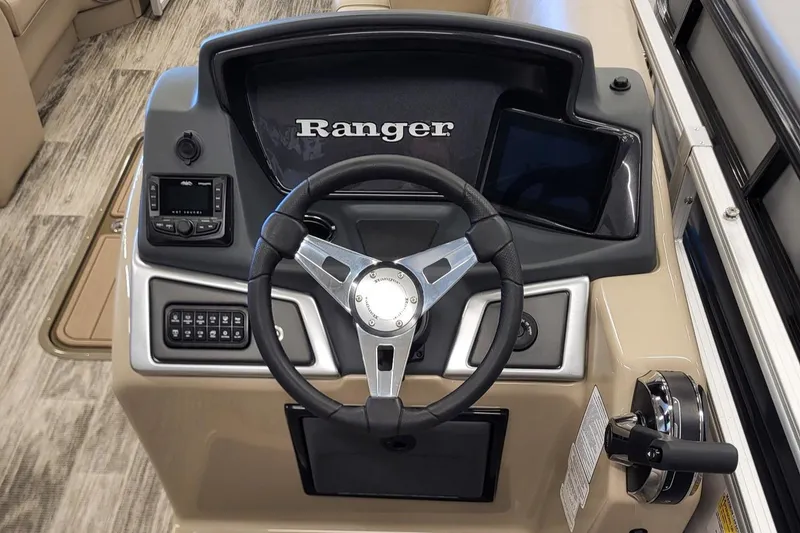 Slide: The Image of 2024 Ranger Reata 223C boat dashboard with steering wheel and controls. - 5