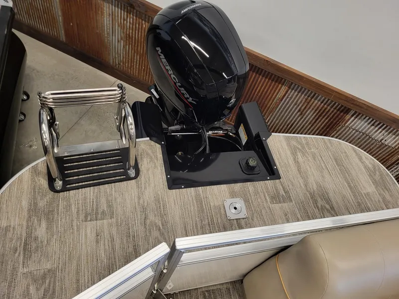 Slide: The Image of 2024 Ranger Reata 223C boat with Mercury outboard motor and boarding ladder. - 7