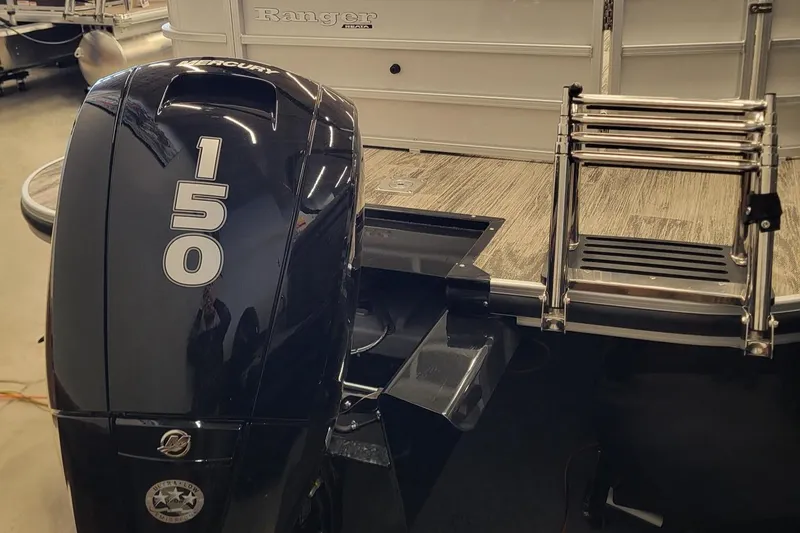 Slide: The Image of 2024 Ranger Reata 223C boat with Mercury 150 outboard motor and boarding ladder. - 8