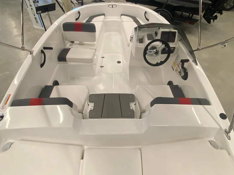 Slide: The Image of 2024 Tahoe T16 boat interior with seating and steering console. - 6