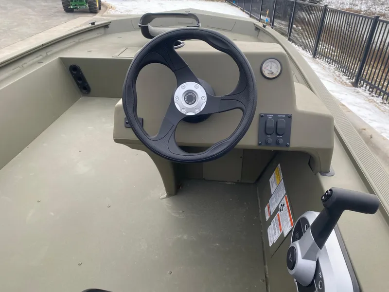 Slide: The Image of 2024 Tracker Grizzly 1754 SC boat interior with steering wheel and control panel. - 3