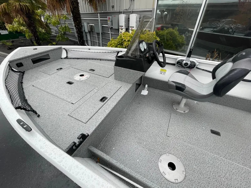 Slide: The Image of 2024 Crestliner 1650 Discovery SC boat interior with seating and storage compartments. - 5
