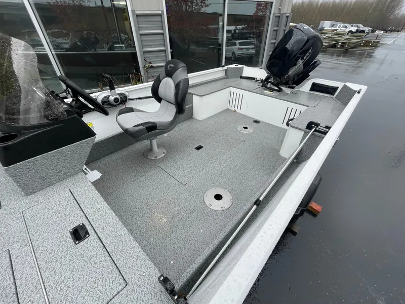 Slide: The Image of 2024 Crestliner 1650 Discovery SC boat with spacious deck and modern seating. - 8