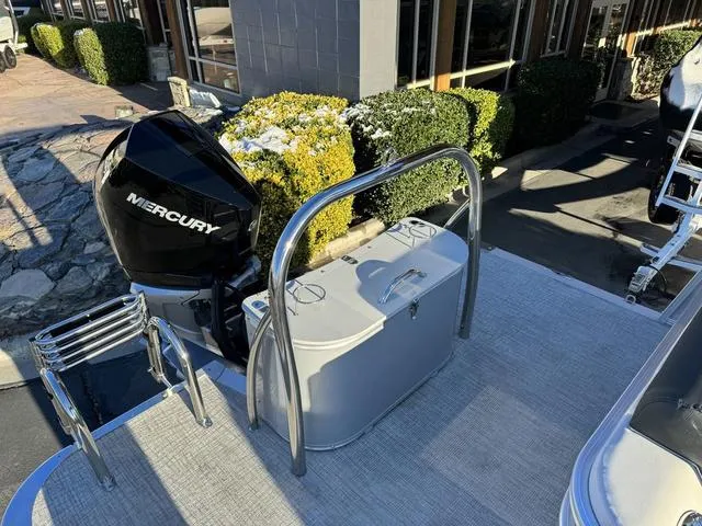 Slide: The Image of 2024 Avalon LSZ Versatile Rear Lounger 23 FT with Mercury engine, outdoor setting. - 11