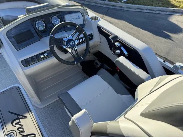 Slide: The Image of 2024 Avalon LSZ Versatile Rear Lounger boat cockpit with steering wheel and controls. - 14