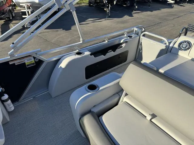 Slide: The Image of 2024 Avalon LSZ Versatile Rear Lounger 23 FT boat interior with seating and cup holders. - 15