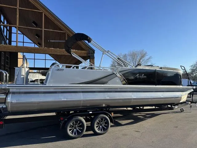Slide: The Image of 2024 Avalon LSZ Versatile Rear Lounger 23 FT pontoon boat on trailer, outdoor setting. - 8