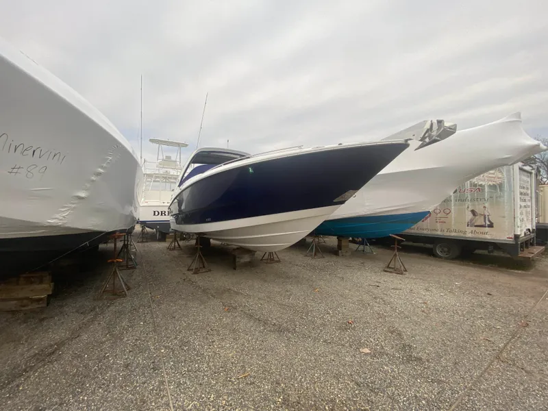The Image of 2016 Monterey 328 Super Sport boat in storage, surrounded by other boats. - 0
