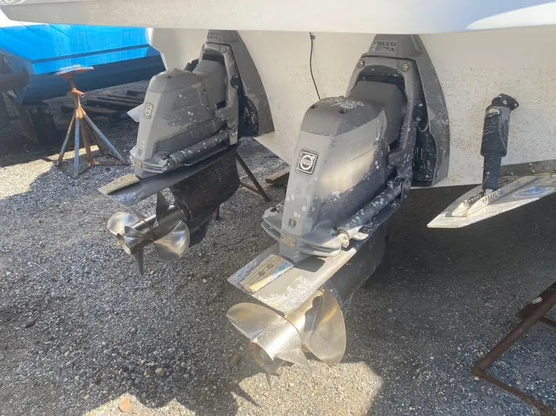 Slide: The Image of 2016 Monterey 328 Super Sport boat propellers and outdrives on gravel. - 11