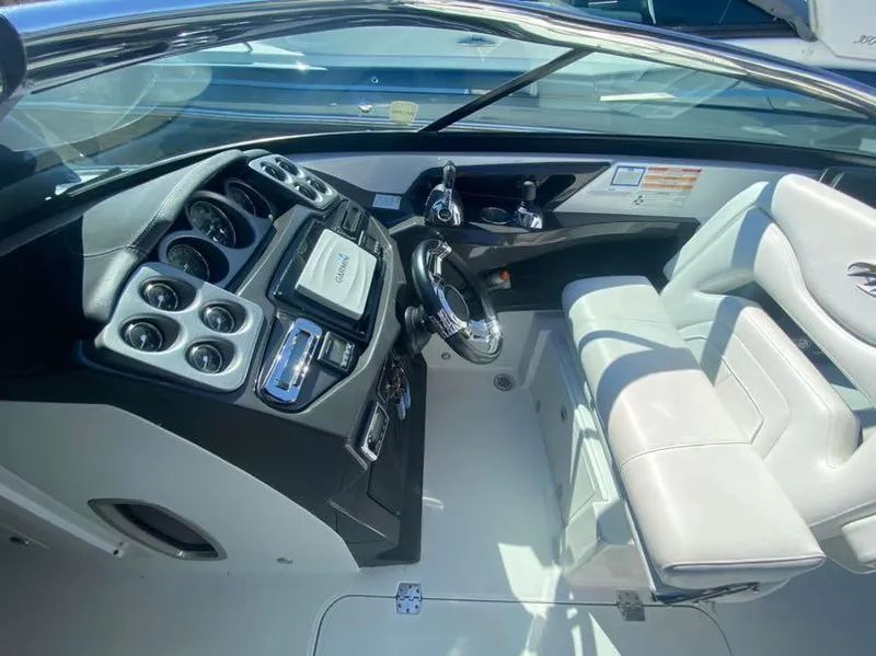Slide: The Image of Cockpit of a 2016 Monterey 328 Super Sport boat with modern controls and white seating. - 2