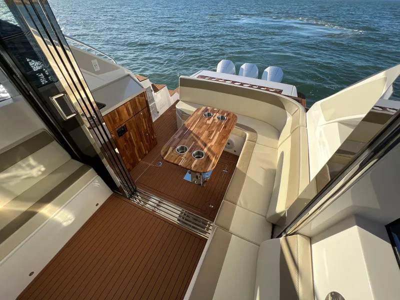 Slide: The Image of 2024 Evolve 400HT luxury yacht with outdoor seating and ocean view. - 14