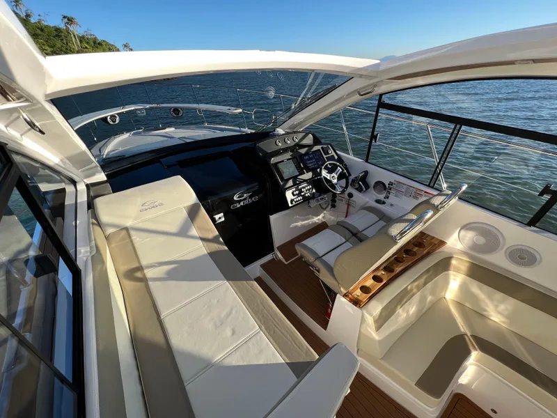 Slide: The Image of 2024 Evolve 400HT yacht cockpit with luxurious seating and advanced navigation controls. - 16