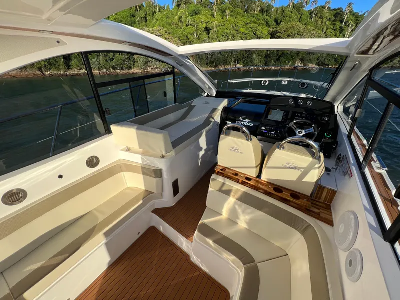 Slide: The Image of 2024 Evolve 400HT luxury yacht interior with modern seating and control panel. - 17