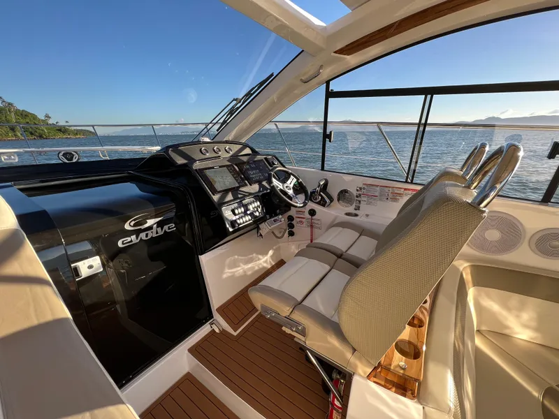 Slide: The Image of 2024 Evolve 400HT yacht cockpit with modern controls and ocean view. - 18