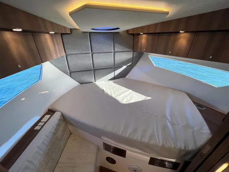 Slide: The Image of 2024 Evolve 400HT boat cabin with modern interior design and comfortable bedding. - 25