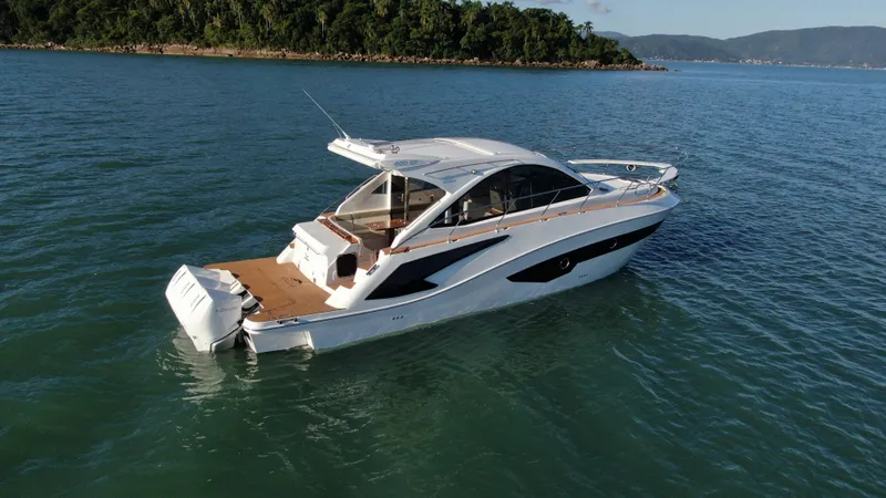 Slide: The Image of 2024 Evolve 400HT luxury yacht cruising on a serene lake. - 8