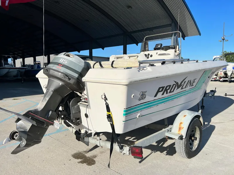 Slide: The Image of 1993 Pro-Line 170 Sportsman boat on trailer with outboard motor. - 2