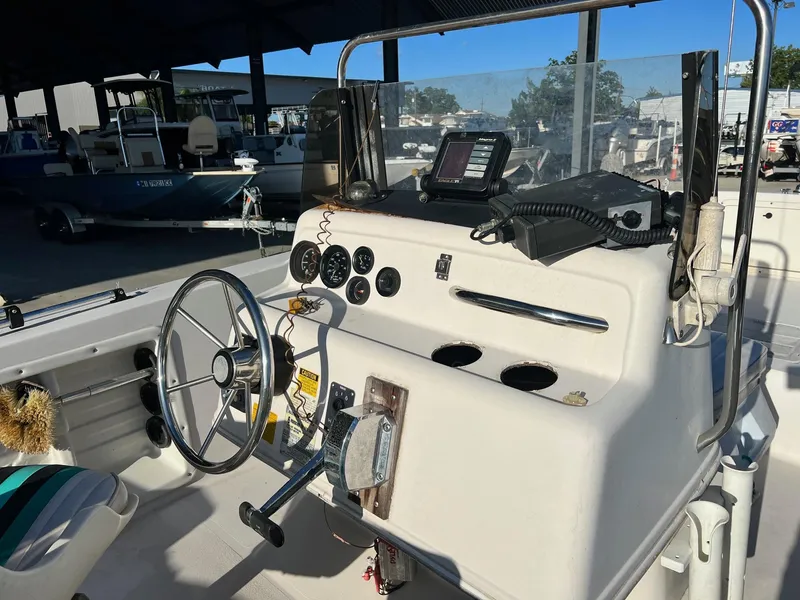 Slide: The Image of 1993 Pro-Line 170 Sportsman boat dashboard with steering wheel and navigation equipment. - 4