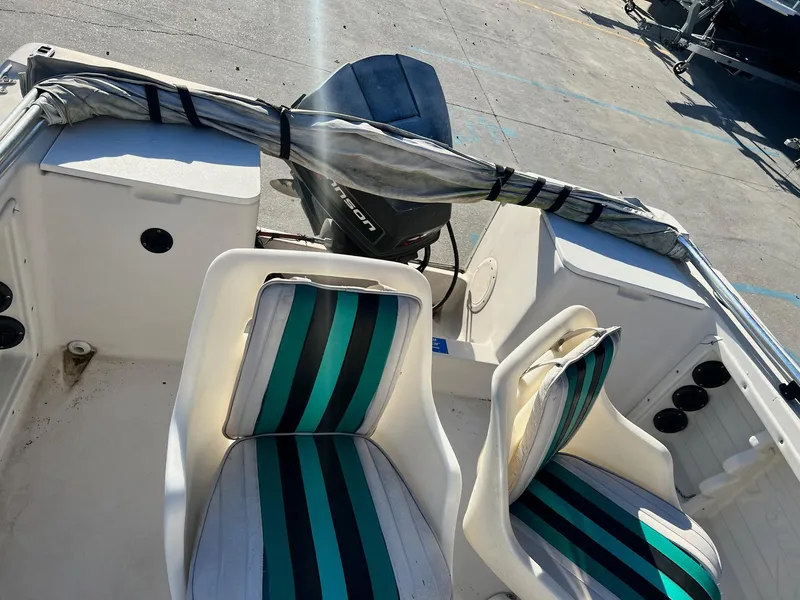 Slide: The Image of 1993 Pro-Line 170 Sportsman boat interior with striped seats and outboard motor. - 5