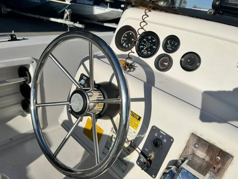 Slide: The Image of 1993 Pro-Line 170 Sportsman boat steering wheel and dashboard controls. - 7