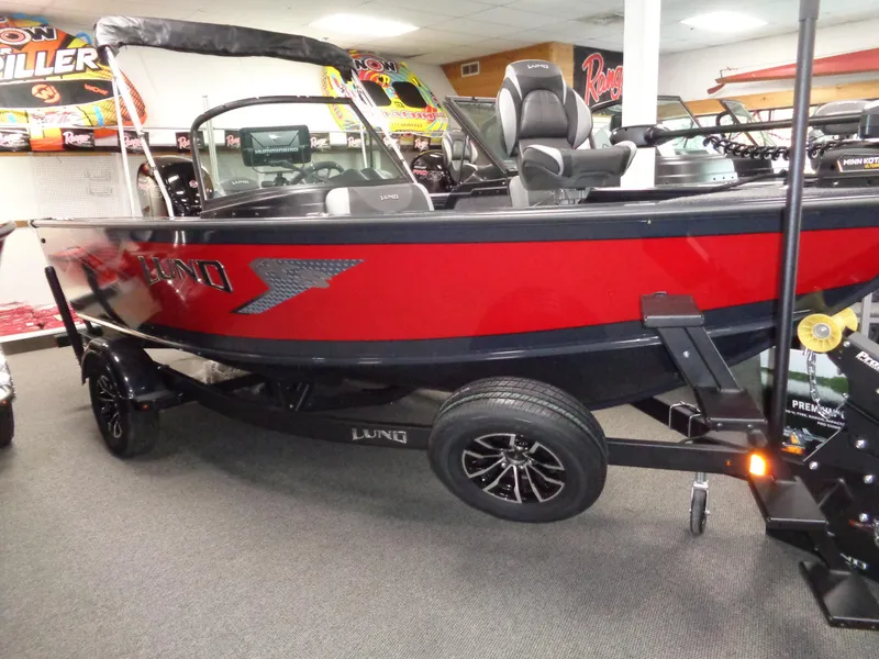 The Image of 2024 Lund 1775 Crossover XS boat in showroom, featuring sleek design and modern features. - 0