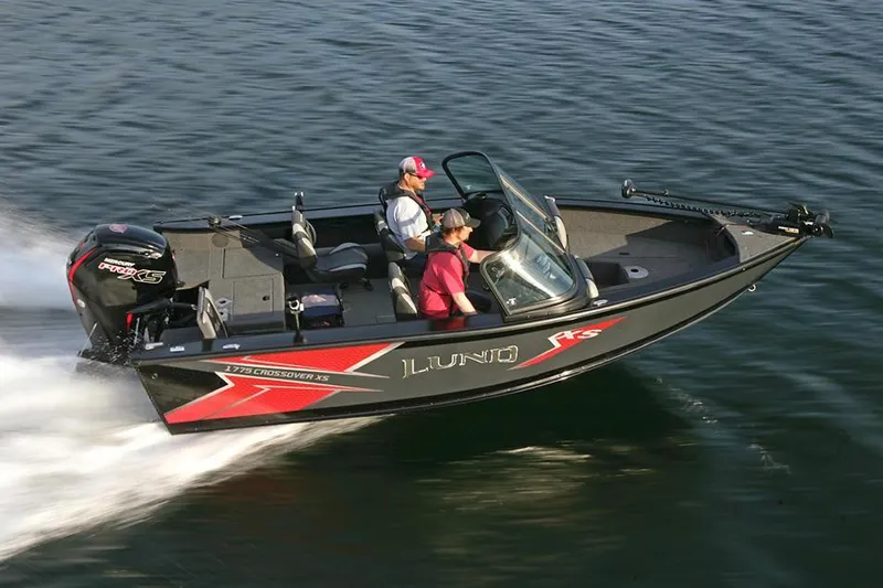 Slide: The Image of 2024 Lund 1775 Crossover XS boat interior with gray seating and modern dashboard. - 12