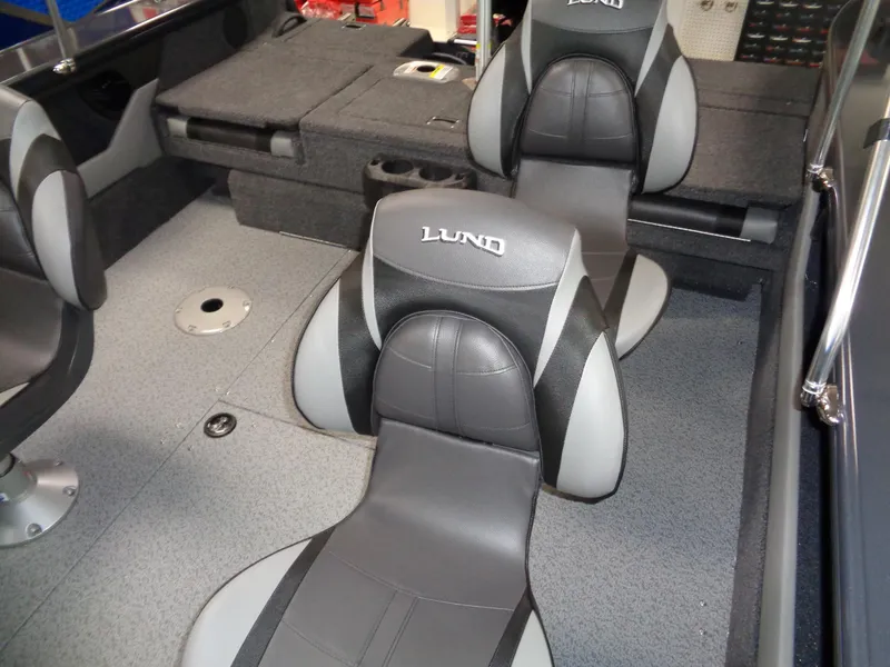 Slide: The Image of 2024 Lund 1775 Crossover XS boat on trailer, side view with red and gray graphics. - 5