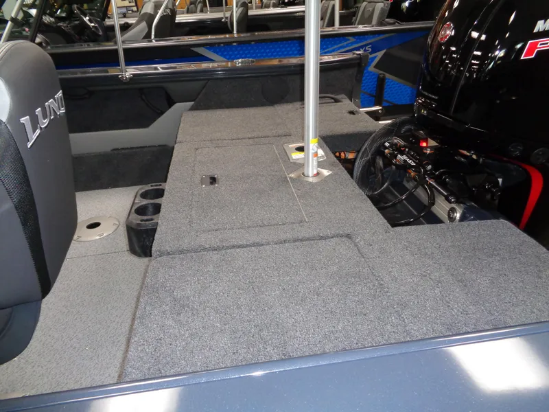 Slide: The Image of 2024 Lund 1775 Crossover XS interior with gray and black seating. - 6