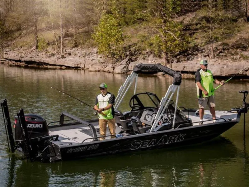 Slide: The Image of 2024 SeaArk ProCat 200 fishing boat on a serene lake with two anglers. - 10