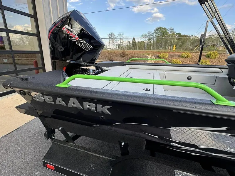 Slide: The Image of 2024 SeaArk ProCat 200 boat with green railings and powerful outboard motor. - 4